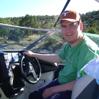 Alex driving a boat