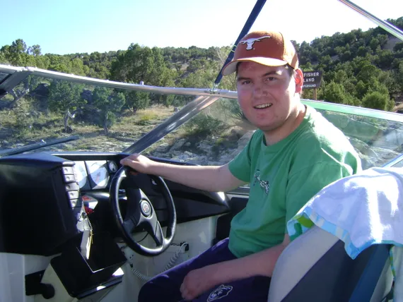 Alex driving a boat